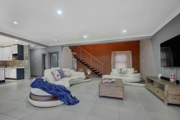 Welcome to this stunning modern industrial move-in ready home, designed with high ceilings and open plan living with stacked doors that extent to the wrap around garden . As you enter you are greeted by a sleek line kitchen with a gorgeous center island ample storage space ...