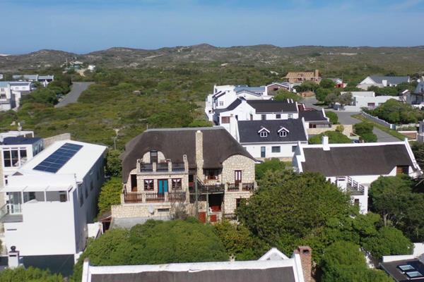 This unique double-story lodge in the enchanting town of Arniston, radiating timeless ...