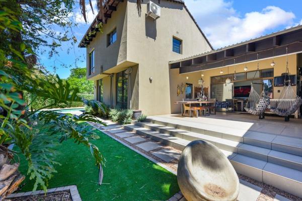 The open-plan living areas are ideal for both family living and entertaining. The kitchen includes wooden countertops, a separate ...