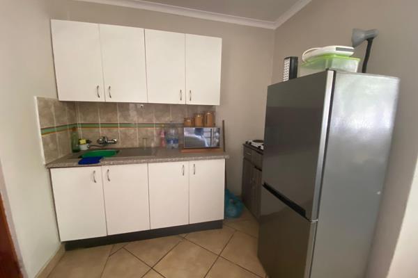 This bachelor flat offers an open plan bedroom/living area with a kitchenette that has built in cupboards and a sink. There is one ...