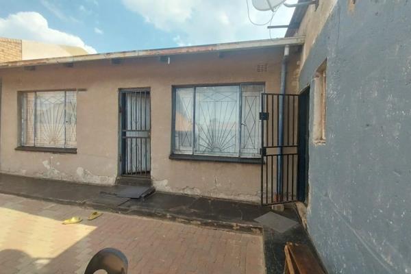 Investment property located in Tembisa, Isithame Section. The main house features two bedrooms, a lounge, a kitchen, and a full ...