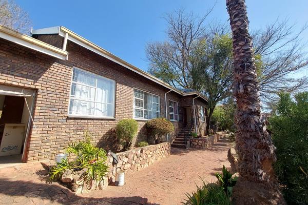 This lovely three-bedroom, two-bathroom home is nestled against the Magaliesberg ...