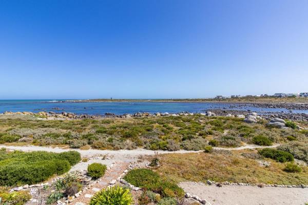 Discover this stunning beachfront home in tranquil Jacobsbaai, offering direct access to ...