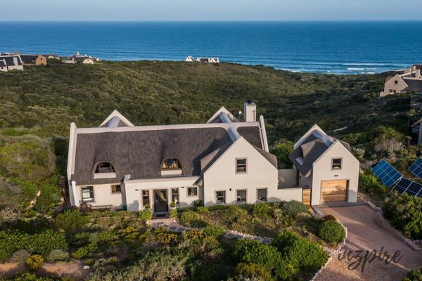 Escape to tranquility with this charming thatch-roof cottage in Springerbaai Eco Estate ...