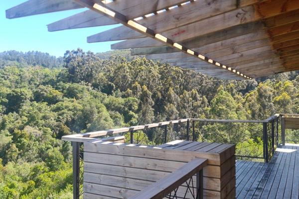 Tucked among the serene trees just above the Knysna River, this charming Simola River ...