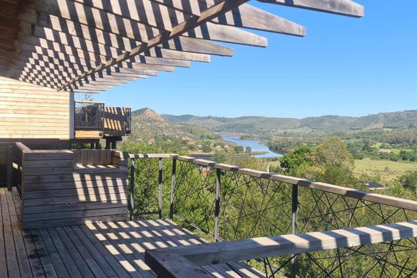 Tucked among the serene trees just above the Knysna River, this charming Simola River ...