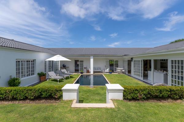 Nestled in a serene area of Plettenberg Bay, this beautiful U-shaped property is designed around a central dark-hued pool that offers a ...