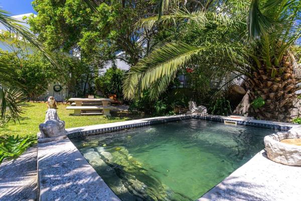 This delightful coastal escape is nestled within a lush, tranquil garden, alive with ...