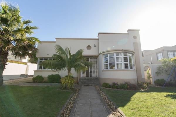 Art deco home with high ceilings and wooden floors.  This home has open plan living ...