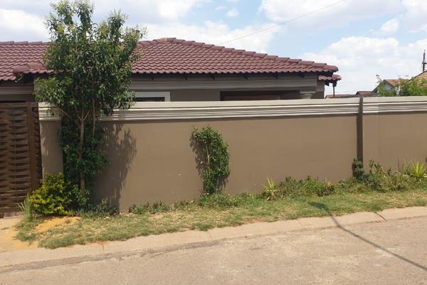 4 bedroom house with open plan kitchen and lounge, dining room, bathroom, ensuite, garage, wall and gate