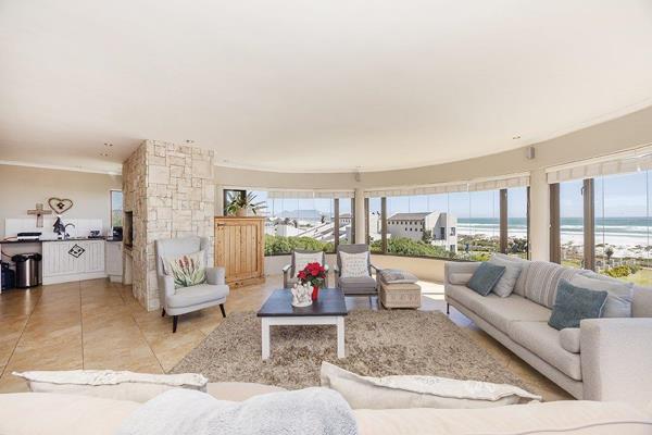 Nestled in exclusive Van Riebeeckstrand, this magnificent two-story seaside villa ...