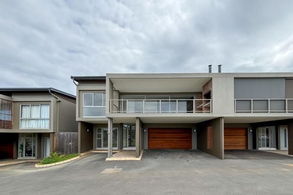 Modern family home in Simbithi Eco Estate. The upper entrance level features a modern kitchen with a centre island and separate ...