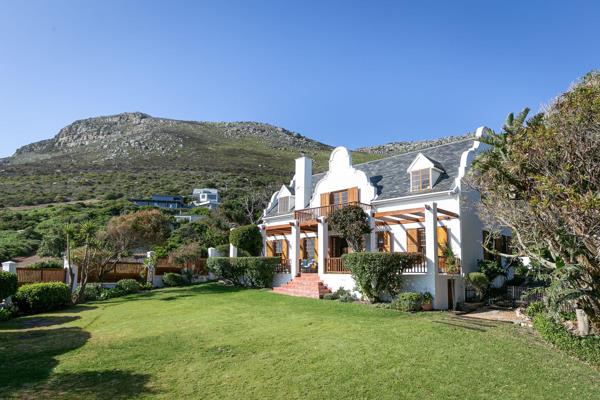 This stunning Cape Dutch-style family home seamlessly blends timeless elegance with ...