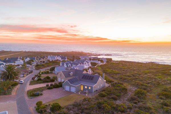 Embrace the coastal allure of this exceptional contemporary beach house nestled within ...