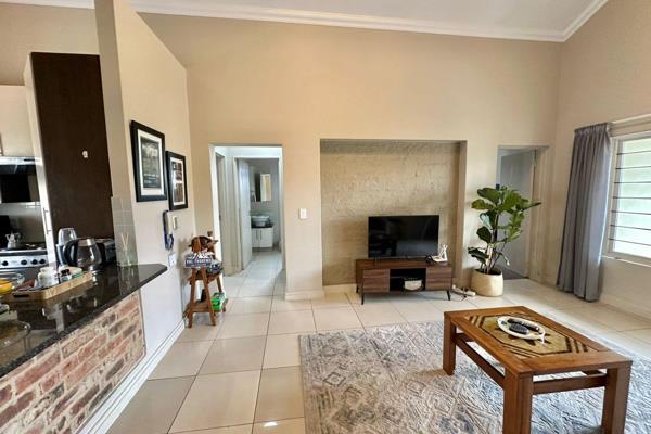 Upstairs unit. The open plan kitchen includes built in cupboards, an oven, stove ...