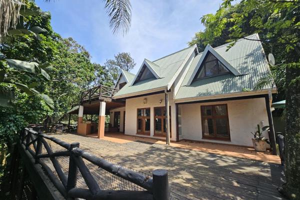 This charming double-story home, featuring a rustic wooden exterior, is a diamond in the ...