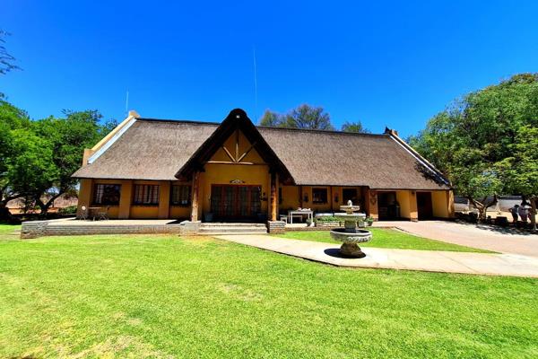 This impressive, thatched roof house on a 4712m&#178; erf, is an exquisite blend of elegance and comfort, offering a spacious living ...