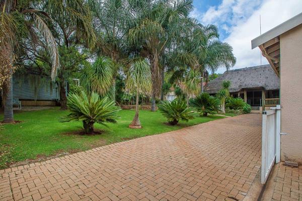 This is no average home!  A tropical paradise awaits when you enter with ample space for ...