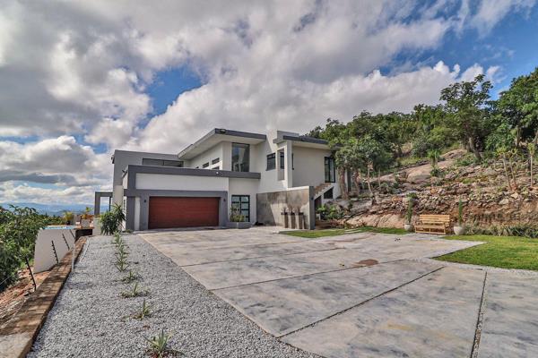 Modern and Stylish 3-Bedroom Home with Stunning Features

Enter through the double doors of this modern home. The entrance has a rock ...