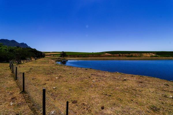 Nestled in the heart of Riebeek Kasteel, this unique gem is the last remaining piece of land offering uninterrupted, breathtaking views of the dam, vineyards, and the majestic mountains beyond. Positioned in the quietest part of ...