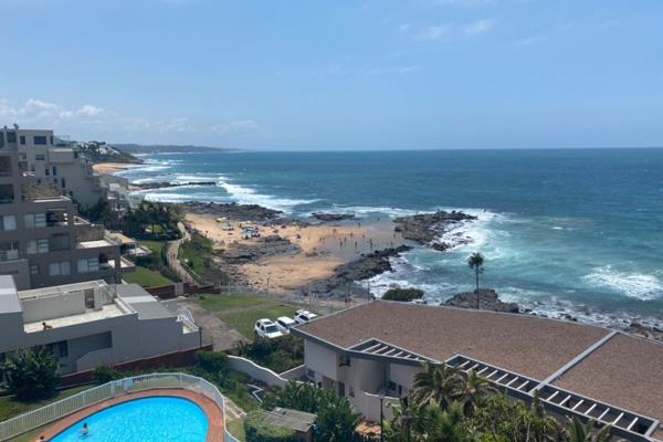 Exceptional sea &amp; coastline views abound from this 2 bedroom apartment in a popular beachfront complex.

The open plan living area ...