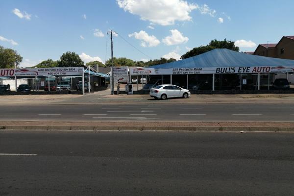 Large commercial property housing the car dealership on the main street through ...