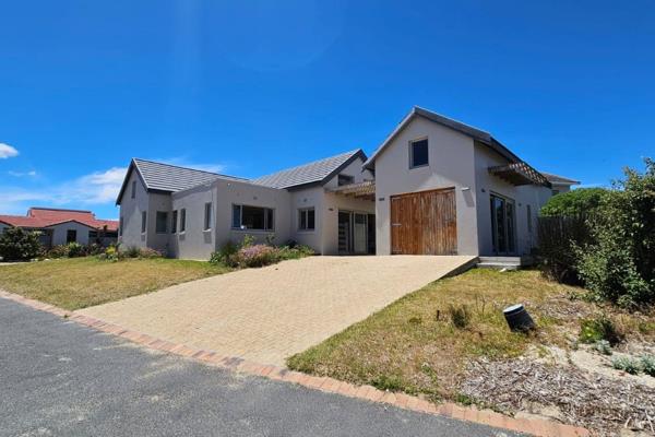 Nestled between the serene lagoon and the vast ocean, 24 Sandown Bay in Meerenbosch ...