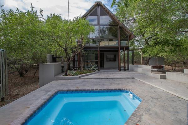 Nestled in the heart of Marloth Park, this exceptional 3-bedroom, 3-bathroom home seamlessly blends modern elegance with natural ...