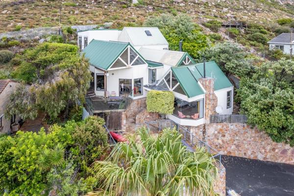 This spacious cladded wooden house on stilts is a five-bedroom, three-bathroom home that ...