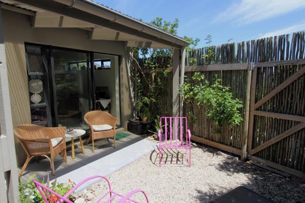 Fig trees and greenery line the stepping stones that lead to the private courtyard of this lovely, neat apartment located in ...