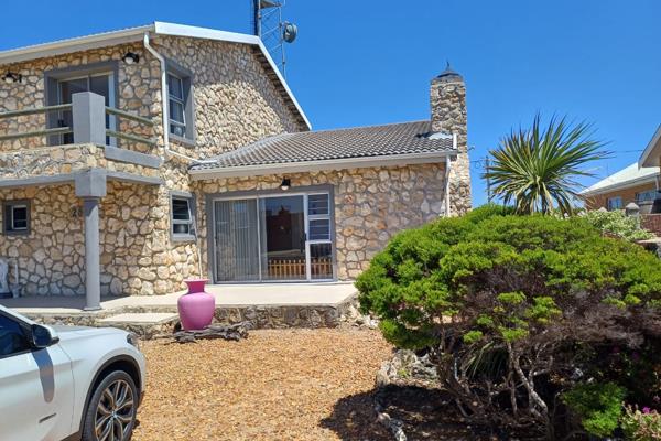 Situated in the tranquil coastal village of Struisbaai, this charming face brick ...