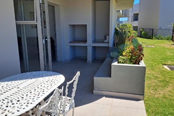 Ground Floor Apartment with a built-in braai on the open patio overlooking the garden and distant sea views.
The modern open-plan ...