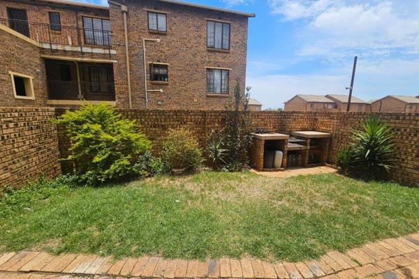 The apartment boasts a beautiful, spacious garden with a built-in braai area, perfect ...