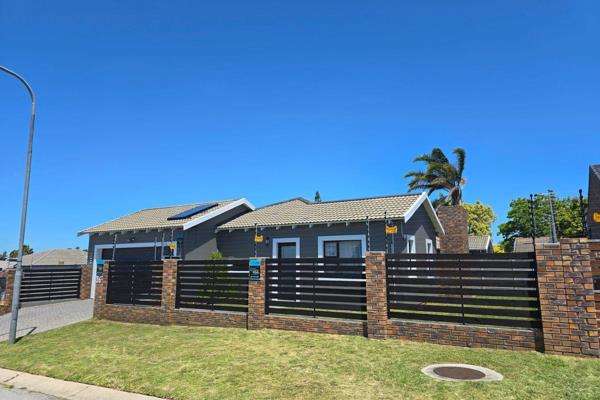 This modern home boasts an open-plan kitchen featuring a stylish island with marble countertops, complemented by a gas hob and electric ...