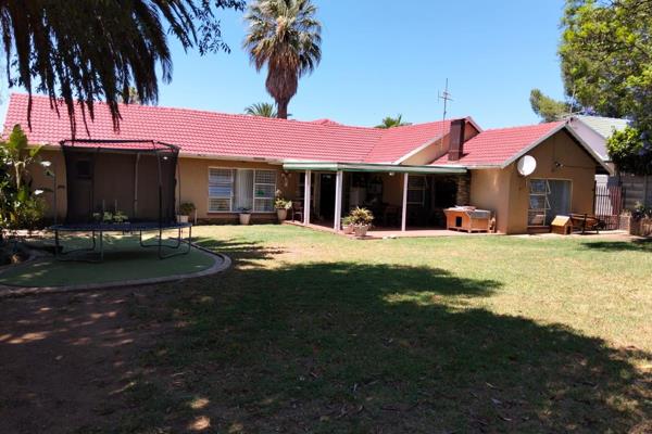 Welcoming Lounge with Fireplace and Dining Room leads to the covered Patio with built in braai and Private Garden. Hear the laughter ...