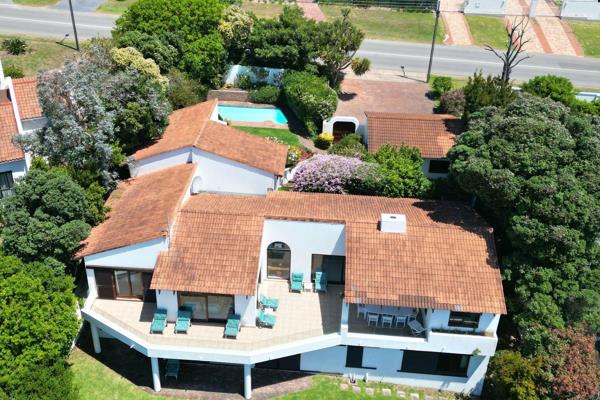 This expansive 5-bedroom home boasts breathtaking panoramic views of Robberg Beach, the ...