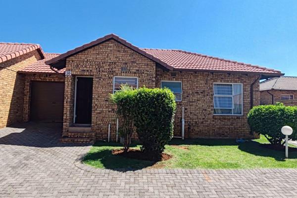 Spacious face brick townhouse with open plan design, featuring a lounge opening to the ...