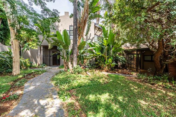 This stunning double-story home features modern finishes and sleek white epoxy flooring ...