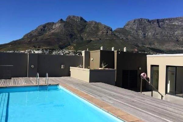 Located in the heart of the city, this stunning apartment offers breathtaking views of Table Mountain, Lion&#39;s Head, and the vibrant ...