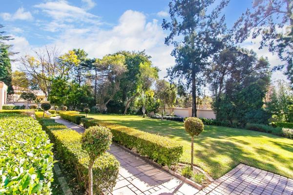 Set in a beautifully landscaped garden, this home blends traditional wood elements with ...