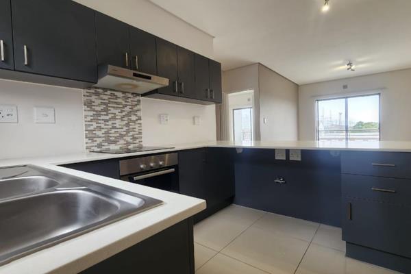 This two-bedroom apartment has an open-plan kitchen which leads to the lounge and dining ...