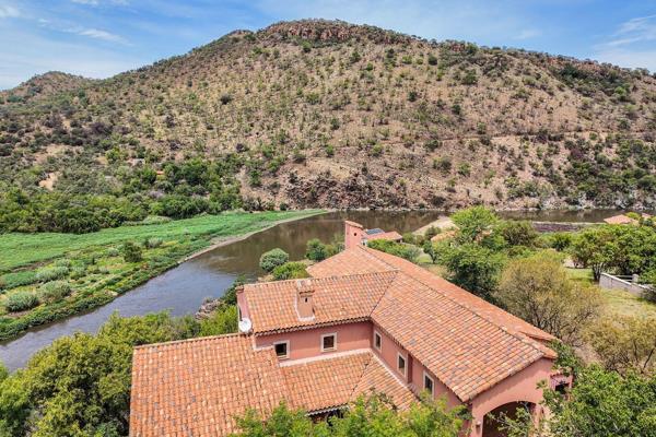 This Hoffman architectural masterpiece is nestled on a cliff overlooking the meandering Crocodile River which finds its way into the ...