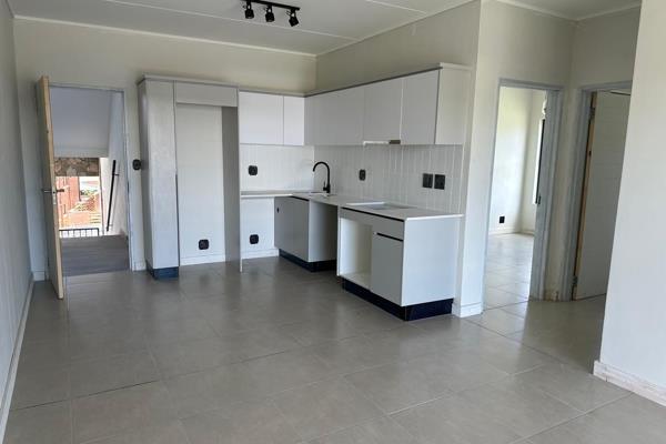 2 bedroom 2 bathroom(both en suite) unit in The Reid 
Main bathroom has a bath and a shower
Kitchen comes with basic appliances

Thus ...