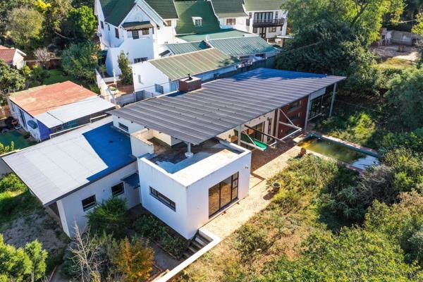 The heart of the home is a stunning open-plan kitchen, living, and dining area, perfectly blending wood, metal, and steel for a modern ...