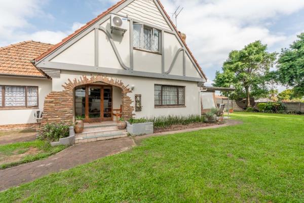 Step into the charm and elegance of this exquisite double-story Tudor-style home ...