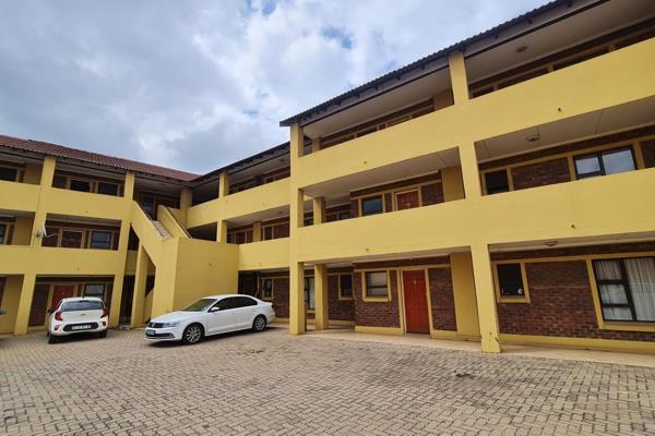 Contemporary open-plan living space featuring a seamless integration of the living room and kitchen. Enjoy a lovely balcony with scenic ...