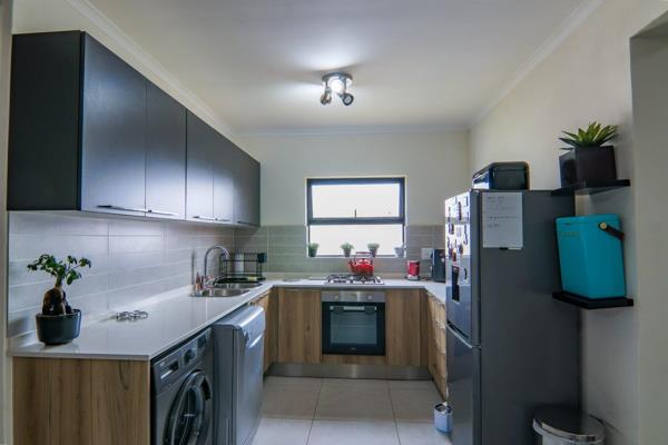 -VIEWINGS BY APPOINTMENYT ONLY - The open-plan kitchen has been carefully crafted, featuring a gas stove, electric oven, and plenty of ...