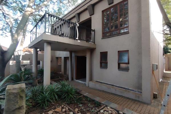 Step into this modern living unit through the striking wooden swivel door, opening into a spacious living area featuring a cozy ...