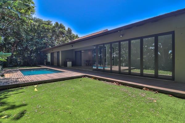 This modern, single-level home offers a private garden and pool in a secluded ...