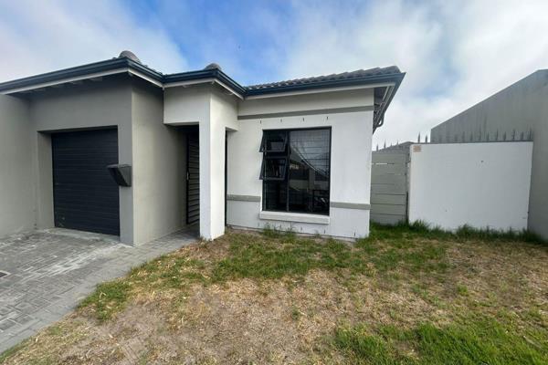 This three-bedroom, two-bathroom home, with open-plan kitchen and living area, garage ...